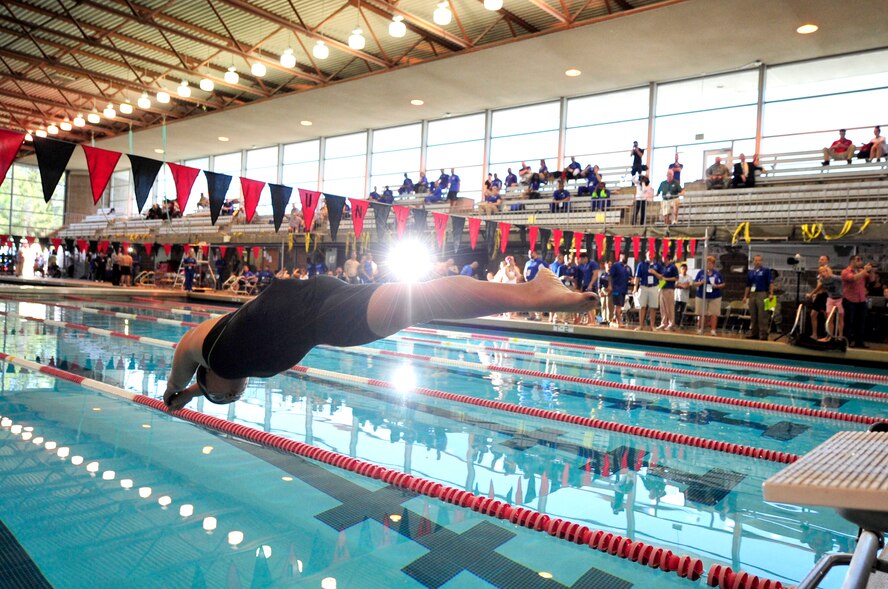 Capt. Sarah Evans, member of the 59th Medical Wing Patients Squadron, dives during a swimming race at the Air Force Wounded Warrior Team Trials at the University of Nevada, Las Vegas, Natatorium swimming pool, April 7, 2014. Evans won first place in the women's 50-meter freestyle swimming competition. (U.S. Air Force photo by Senior Master Sgt. Cecilio Ricardo)