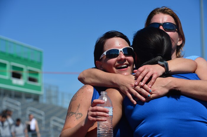 (Ret.) Tech. Sgt. Monica Figueroa is hugged by (Ret.) Staff Sgt. Melissa Guzman (left) and (Ret.) Senior Airman Marianne Reilly after completing in the women's 1500-meter race during the Air Force Wounded Warrior Team Trials, April 8, 2014 at Rancho High School, Las Vegas.  During the trials wounded warriors competed in swimming, basketball, volleyball, track and field events, cycling, archery and shooting competitions. (U.S. Air Force photo by Staff Sgt. Nadine Barclay)
