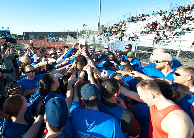 Wounded Warrior athletes huddle up for motivation and camaraderie before the track and field portion of the Air Force Wounded Warrior Team Trials April 8, 2014, at Rancho High School, Las Vegas. Adaptive athletic reconditioning helps wounded warriors build strength and endurance, while they draw inspiration from their team mates. (U.S. Air Force photo by Airman 1st Class Thomas Spangler)