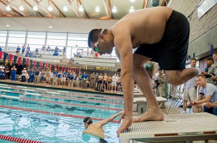 Scott Palomino prepares to dive in the swimming competition of the Air Force Wounded Warrior Team Trials at the University of Nevada, Las Vegas, Natatorium swimming pool, April 7, 2014. Palomino medically retired from the Air Force in 2005 after being injured from a mortar attack at Balad Air Base, Iraq. He and several wounded warriors are competing in swimming, basketball, volleyball, track and field events, cycling, archery and shooting competitions. (U.S. Air Force photo by Senior Master Sgt. Cecilio Ricardo)