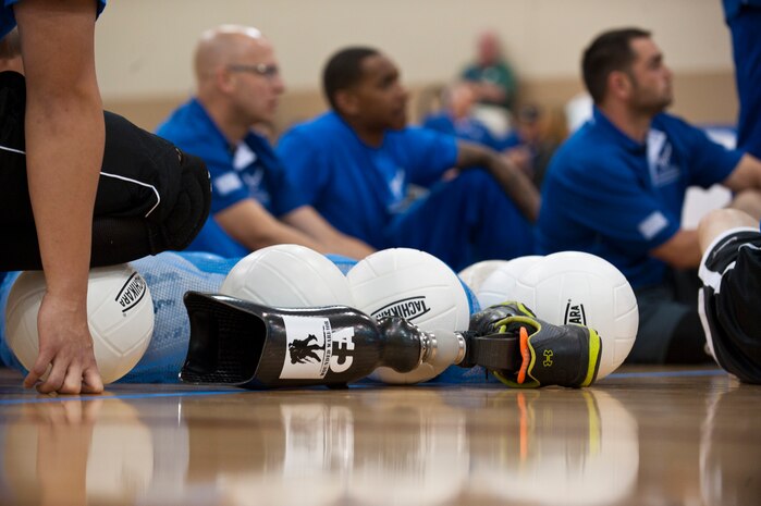 Warrior athletes listen to instructions before a seated volleyball practice at the Air Force Wounded Warrior Team Trials at the Warrior Fitness Center, April 7, 2014, at Nellis Air Force Base, Nev. Fitness and teamwork are a way of military life. Serious illness or injury can profoundly impact that way of life. Adaptive athletic reconditioning helps wounded warriors build strength and endurance, while they draw inspiration from their teammates. (U.S. Air Force photo by Airman 1st Class Thomas Spangler)