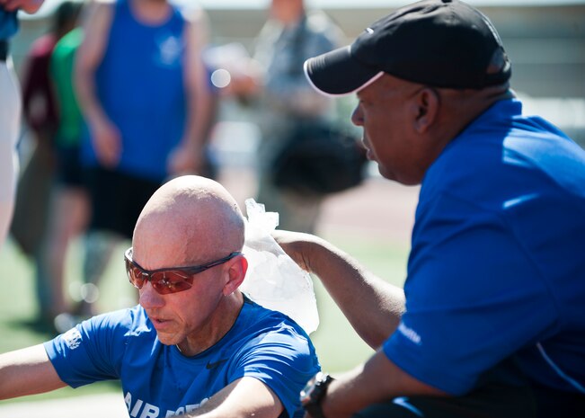 Warrior athlete Michael Sanders, rests with an ice bag held on his back after competing in the men’s 1500-meter race during the track and field portion of the Air Force Wounded Warrior Team Trials, April 8, 2014, at Rancho High School, Las Vegas. In addition to encouraging wounded warriors to compete in adaptive sports, it provides wounded warrior families with a variety of support services, making their jobs as care givers more manageable and helping to alleviate the stress that comes with a major life change. (U.S. Air Force photo by Airman 1st Class Thomas Spangler)