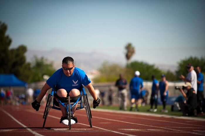 Warrior athlete Andrew Evans, crosses the finish line during the 100-meter wheelchair final during the track and field portion of the Air Force Wounded Warrior Trials, April 8, 2014, at Rancho High School, Las Vegas. Some of the positive effects of adaptive athletic reconditioning include: fewer secondary medical conditions, increased pursuit of higher education, improved employment opportunities, lower stress levels, and greater self-esteem. (U.S. Air Force photo by Airman 1st Class Thomas Spangler)