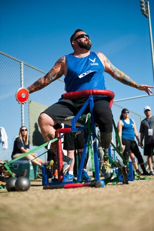 Warrior athlete Steve Malits, throws discuss during the track and field portion of the Air Force Wounded Warrior Trials, April 8, 2014, at Rancho High School, Las Vegas. Athletes participating in the trials are service members with upper-body, lower-body, and spinal cord injuries serious illnesses, traumatic brain injuries, visual impairment, and post-traumatic stress disorder. (U.S. Air Force photo by Airman 1st Class Thomas Spangler)