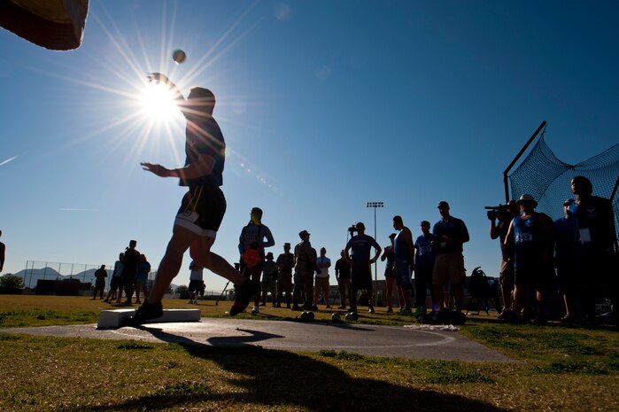 Warrior athlete Mitch Kiefer, throws a shot put during the track and field portion of the Air Force Wounded Warrior Team Trials, April 8, 2014, at Rancho High School, Las Vegas.  Fitness and teamwork are a way of life in the military. Serious illness and injury can have a profound impact on that way of life. Air Force Wounded Warrior encourages these recovering warriors to make adaptive sports a part of their recovery. (U.S. Air Force photo by Airman 1st Class Thomas Spangler)