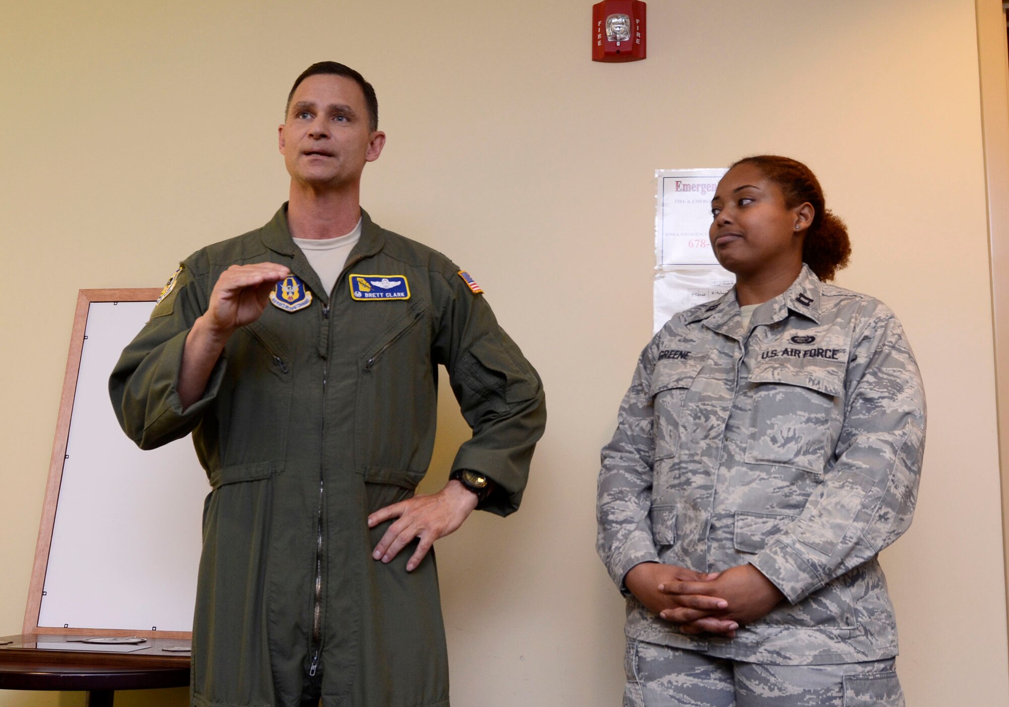 Col. Brett Clark, 94th Airlift Wing commander, congratulates Capt. Melissa Greene, former 94th AW executive officer with a gift as she departs Dobbins Air Reserve Base March 13, and begans the next stage of her Air Force career. Green served as the 94th Mission Support Group executive officer 2009-2011, and as the 94th Force Support Squadron Personnel Systems and Readiness officer-in-charge. (U.S. Air Force photo/Don Peek)