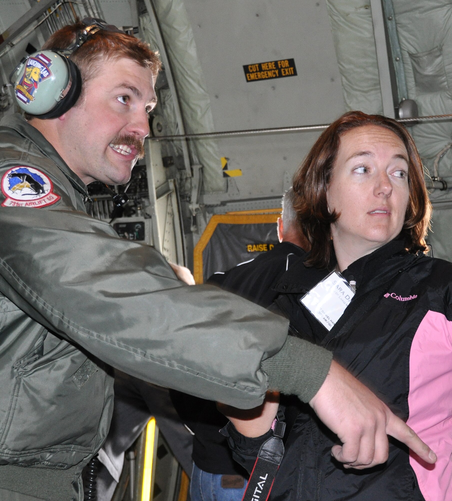 Master Sgt. Chris Linquist, a C-130 loadmaster and 302nd Airlift Wing reservist, talks with Sara Dawson, a state procurement analyst for the Bureau of Land Management, during a training flight above Pikes Peak April 4, 2014. Dawson joined 42 others for a day designed to educate employers on the uniqueness of the Air Force Reserve. (U.S. Air Force photo/Master Sgt. Daniel Butterfield)