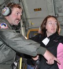 Master Sgt. Chris Linquist, a C-130 loadmaster and 302nd Airlift Wing reservist, talks with Sara Dawson, a state procurement analyst for the Bureau of Land Management, during a training flight above Pikes Peak April 4, 2014. Dawson joined 42 others for a day designed to educate employers on the uniqueness of the Air Force Reserve. (U.S. Air Force photo/Master Sgt. Daniel Butterfield)