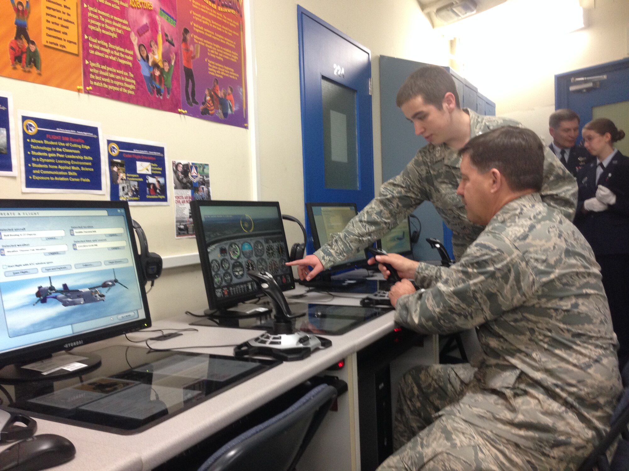 Brig. Gen. John P. Horner, Air Force Recruiting Service commander (foregound), tests his piloting skills March 13 in a Science, Technology, Engineering and Math laboratory built by Air Force Junior ROTC cadets at Yokota High School, Japan. Horner visited the high school during his tour of the 369th Recruiting Squadron which has offices throughout the Pacific Rim of Asia and Oceania, March 9-19. (U.S. Air Force photo)