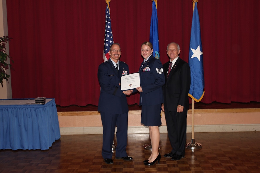 Brig. Gen. Robert D. LaBrutta, 502nd Air Base Wing commander (left), and Al Swaim, Air Force Association Alamo Chapter president (right) present Tech. Sgt. Talia Walterswith the Recruiter of the Year Award at the AFA Alamo Chapter Annual Awards Banquet at Joint Base San Antonio-Lackland, Texas, March 25. Walter is assigned to the 341st Recruiting Squadron. (U.S. Air Force photo)