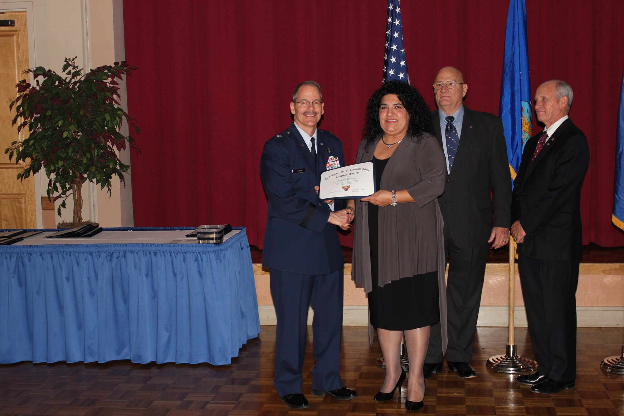 Brig. Gen. Robert D. LaBrutta, 502nd Air Base Wing commander (left), retired Air Force Col. James W. Kellogg, former Air Force Association Alamo Chapter vice president (second from right), and Al Swaim, chapter president (right) present Jennifer Therriat with The Charlotte and Carlton Loos Civilian Award at the chapter’s  annual awards banquet at Joint Base San Antonio-Lackland, Texas, March 25. Therriat is chief of Civilian Personnel Programs at Headquarters Air Force Recruiting Service. (U.S. Air Force photo)