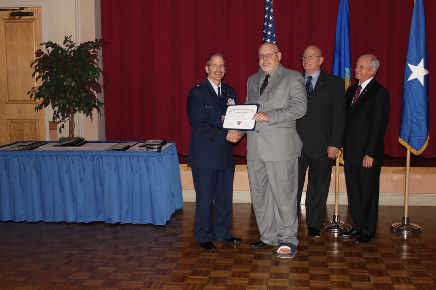 Brig. Gen. Robert D. LaBrutta, 502nd Air Base Wing commander (left), retired Air Force Col. James W. Kellogg, former Air Force Association Alamo Chapter vice president (second from right), and Al Swaim, chapter president (right) present Frank Radis with The Charlotte and Carlton Loos Civilian Award at the chapter’s annual awards banquet at Joint Base San Antonio-Lackland, Texas, March 25. Radis is the account executive with the Strategic Communications Division at Headquarters Air Force Recruiting Service. (U.S. Air Force photo)