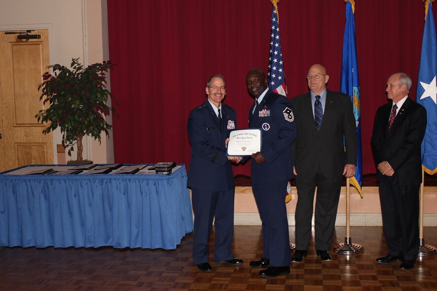 Brig. Gen. Robert D. LaBrutta, 502nd Air Base Wing commander (left), and retired Air Force Col. James W. Kellogg, former AFA Alamo Chapter vice president (right), present Master Sgt. Melvin Jacksonwith The Colonel Joe Kellogg Blue Suit Award at the chapter’s annual awards banquet at Joint Base San Antonio-Lackland, Texas, March 25. Jackson is the first sergeant with the 341st Recruiting Squadron. (U.S. Air Force photo)