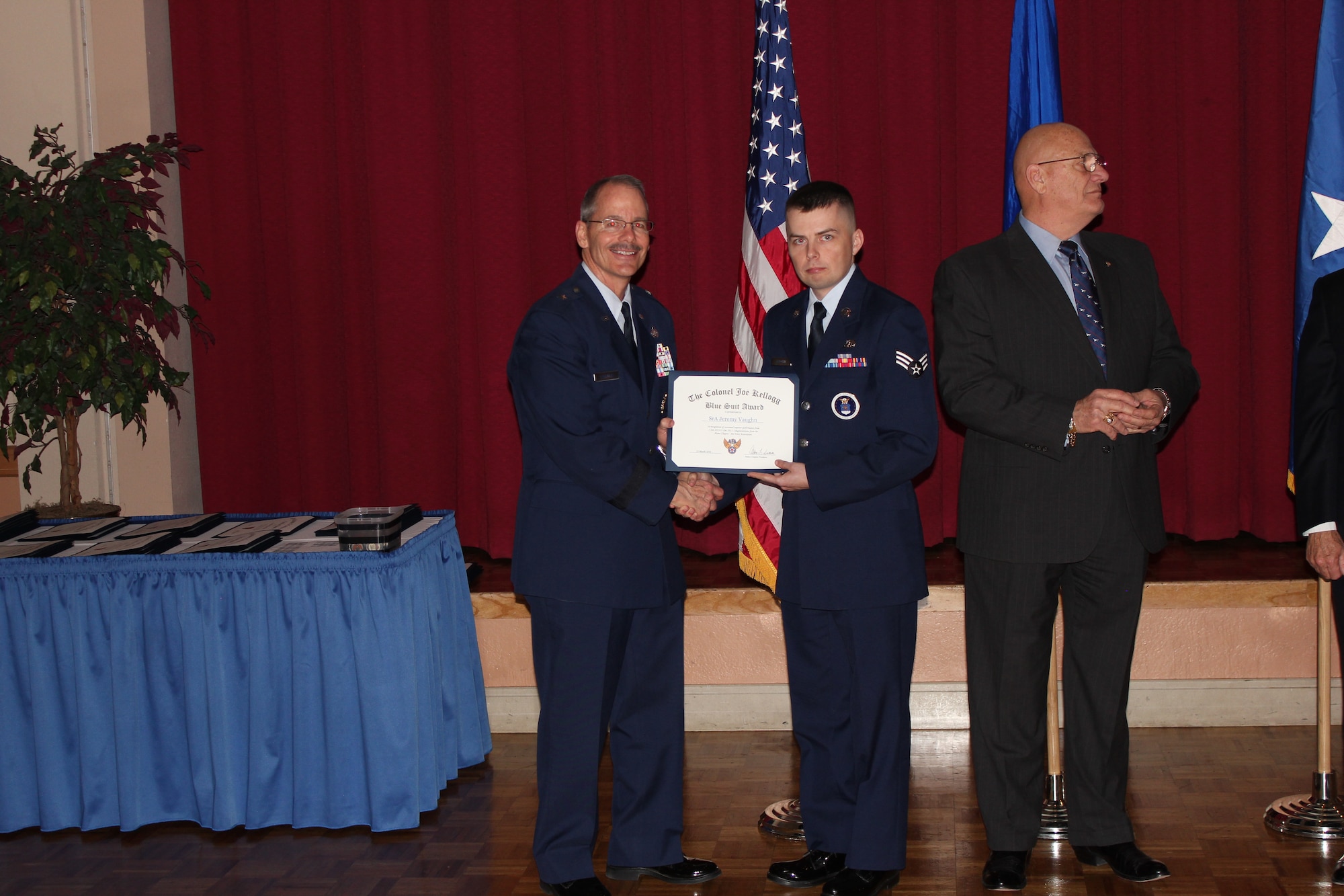Brig. Gen. Robert D. LaBrutta, 502nd Air Base Wing commander (left), presents Senior Airman Jeremy Vaughn with The Colonel Joe Kellogg Blue Suit Award at the Air Force Association Alamo Chapter Annual Awards Banquet at Joint Base San Antonio-Lackland, Texas, March 25. Vaughn is a software developer assigned to the Air Force Recruiting Service Information Systems Division. (U.S. Air Force photo)