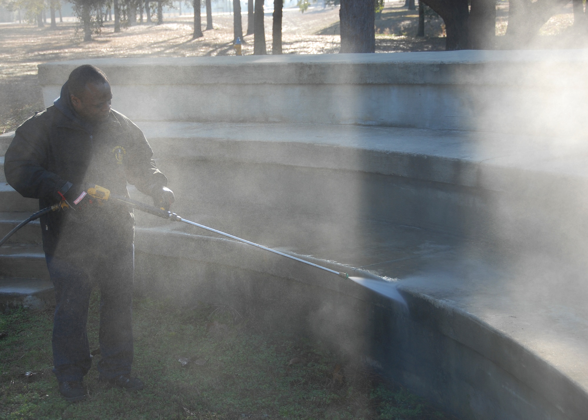 Sturgeon Teemer, of the 796th Civil Engineer Squadron, pressure washes the amphitheater during the Unity Park renovation project.  The park reopened to the Eglin Air Force base community and their families April 1, following four months of renovations.  (U.S. Air Force photo/Kevin Gaddie)