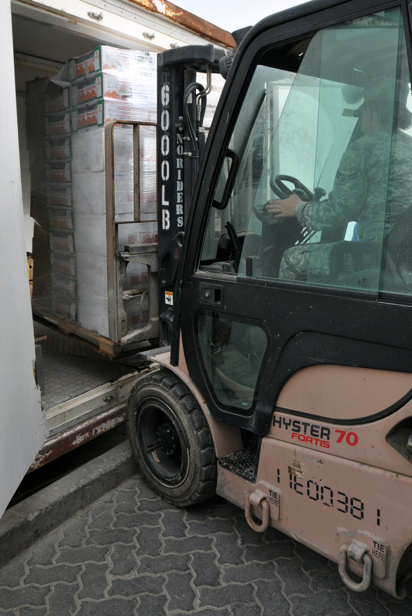 Air Force Airman 1st Class Emma Makransky, 380th Expeditionary Force Support Squadron storeroom assistant, offloads a forklift loaded with food into one of the walk-in freezers here April 3,2014. (U.S. Air Force photo by Master Sgt. April Lapetoda/Released)