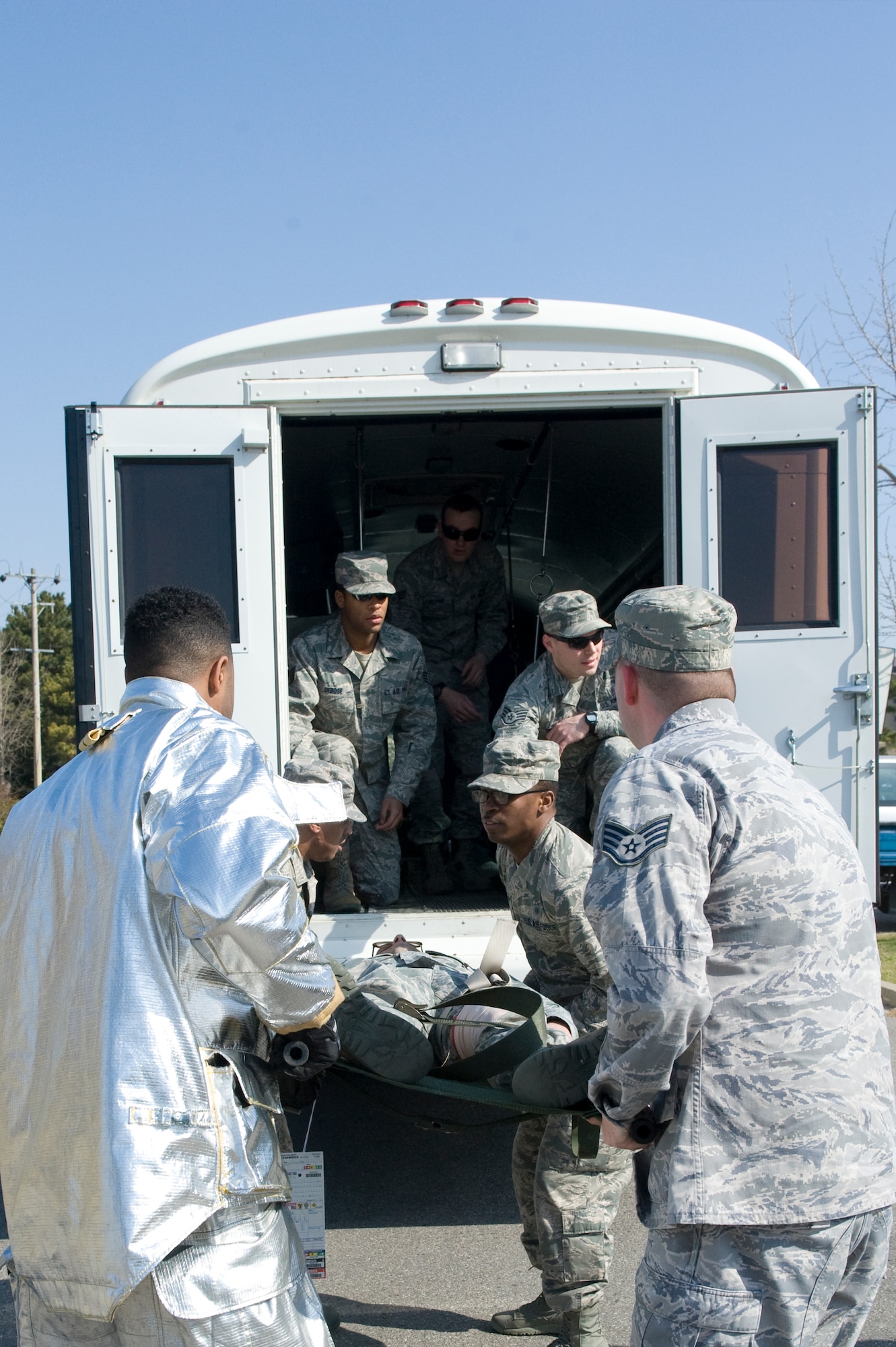Airmen from both the 8th Medical Group and 8th Civil Engineer Squadron work together to transport an injured role player during the active shooter scenario at Kunsan Air Base, Republic of Korea, Apr. 8, 2014. Depending on how critical the injury was, injured role players were transported to either the clinic on-base. (U.S. Air Force photo by Staff Sgt. Jessica Haas/Released)