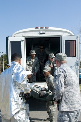 Airmen from both the 8th Medical Group and 8th Civil Engineer Squadron work together to transport an injured role player during the active shooter scenario at Kunsan Air Base, Republic of Korea, Apr. 8, 2014. Depending on how critical the injury was, injured role players were transported to either the clinic on-base or another area to simulate an off-base hospital. (U.S. Air Force photo by Staff Sgt. Jessica Haas/Released)