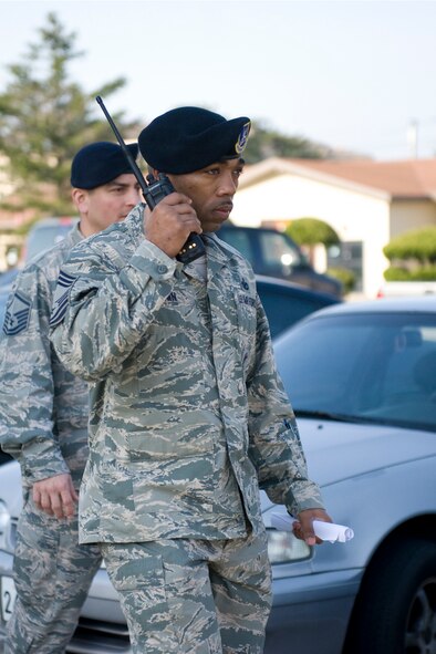 Chief Master Sgt. Samel Brown, 8th Security Forces Squadron security force manager, listens for status updates during the active shooter scenario at Kunsan Air Base, Republic of Korea, Apr. 8, 2014. Brown was part of the wing inspection team and charged with observing how his security forces Airmen responded to the active shooter scenario. (U.S. Air Force photo by Staff Sgt. Jessica Haas/Released)