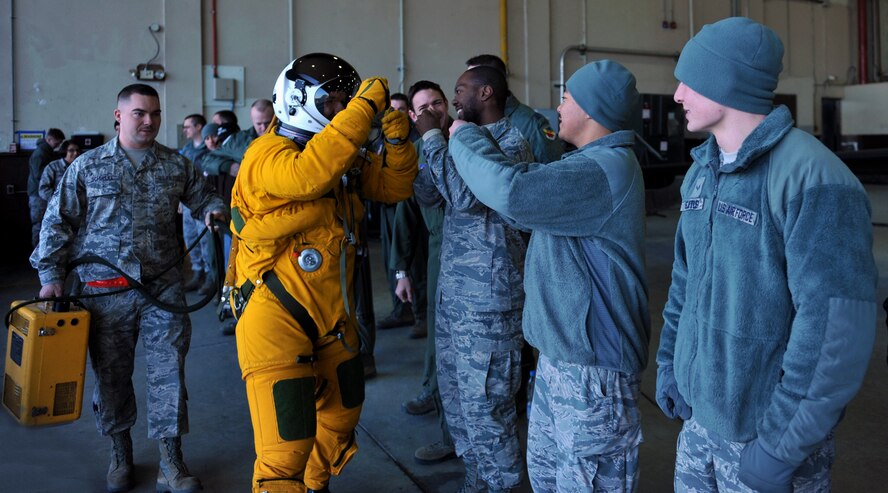 Maj. David (last name withheld due to operational security constraints), 5th Reconnaissance Squadron U-2 Dragon Lady pilot, fist bumps other 5th RS members before flying a mission at Osan Air Base, Republic of Korea, March 10, 2014. Before every mission, the team comes together to see the pilot off and then welcome him back upon his return. (U.S. Air Force photo/Senior Airman Siuta B. Ika)
