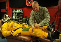 Maj. David (last name withheld due to operational security constraints), 5th Reconnaissance Squadron U-2 Dragon Lady pilot, has the final preparations made to his fully-pressurized suit before flying a mission at Osan Air Base, Republic of Korea, March 10, 2014. Members of the 5th RS’s physiological support division help every U-2 pilot suit up and hook them up to pure oxygen prior to missions. (U.S. Air Force photo/Senior Airman Siuta B. Ika)