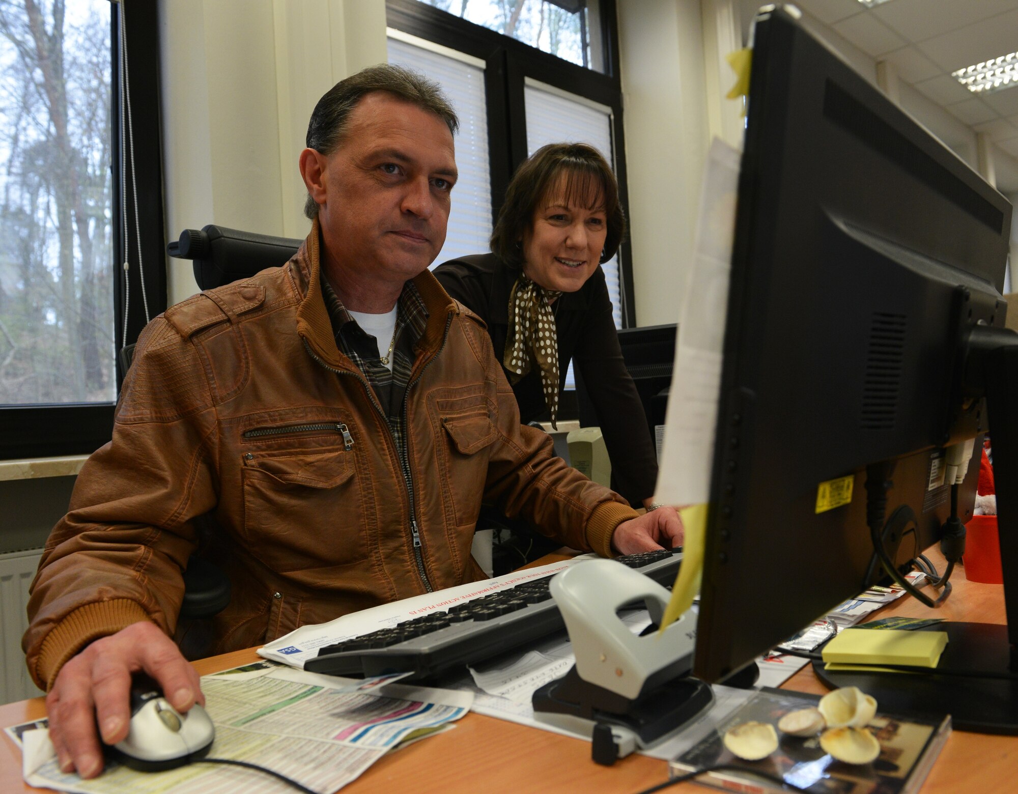 Andreas Schmal, (left) 86th Civil Engineering Squadron housing inspector and Diana Keener, 86th CES facilities chief of housing, work together to assist service members gather housing information April 3, 2014, at Volgelweh Air Station, Germany. The housing flight was awarded the 2013 Brigadier General Michael A. McAuliffe honor for housing excellence. A flight must display ideal housing services, excellent management and exceptional customer support, in order to win this prestigious award. (U.S. Air Force photo/Airman Dymekre Allen)  
