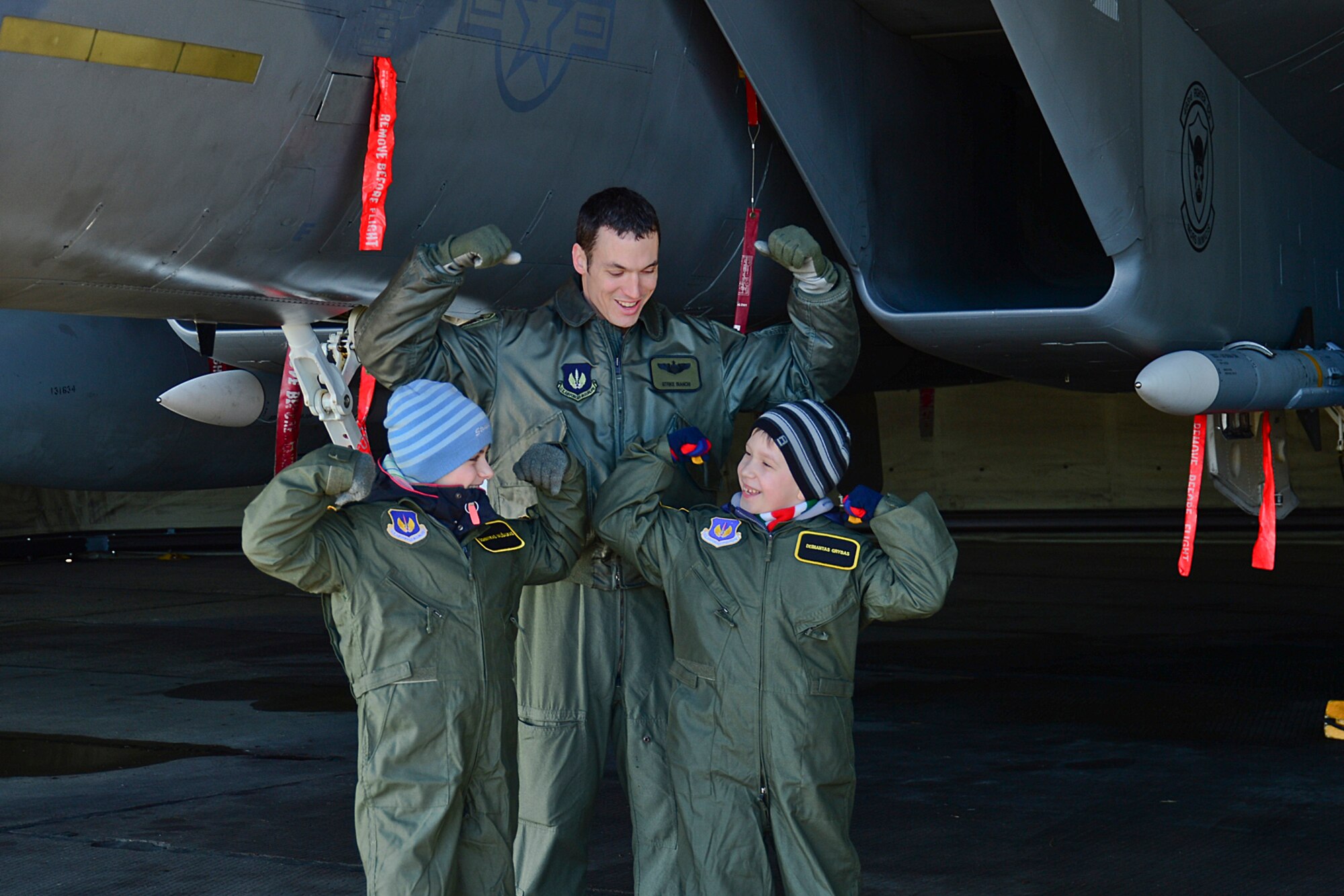 Major Jason Bianchi, 493rd Expeditionary Fighter Squadron pilot, Dominykas Vališaukas and Deimantas Grybas pose for a photo in front of an F-15C Eagle during the ‘Pilot for the Day’ event at Šiauliai Air Base, Lithuania, April 4, 2014. ‘Pilot for a Day’ gives local children with serious illnesses and conditions a day away from routine hospital visits to see the U.S. Air Force mission up close. (U.S. Air Force photo by Airman 1st Class Dana J. Butler/Released)
