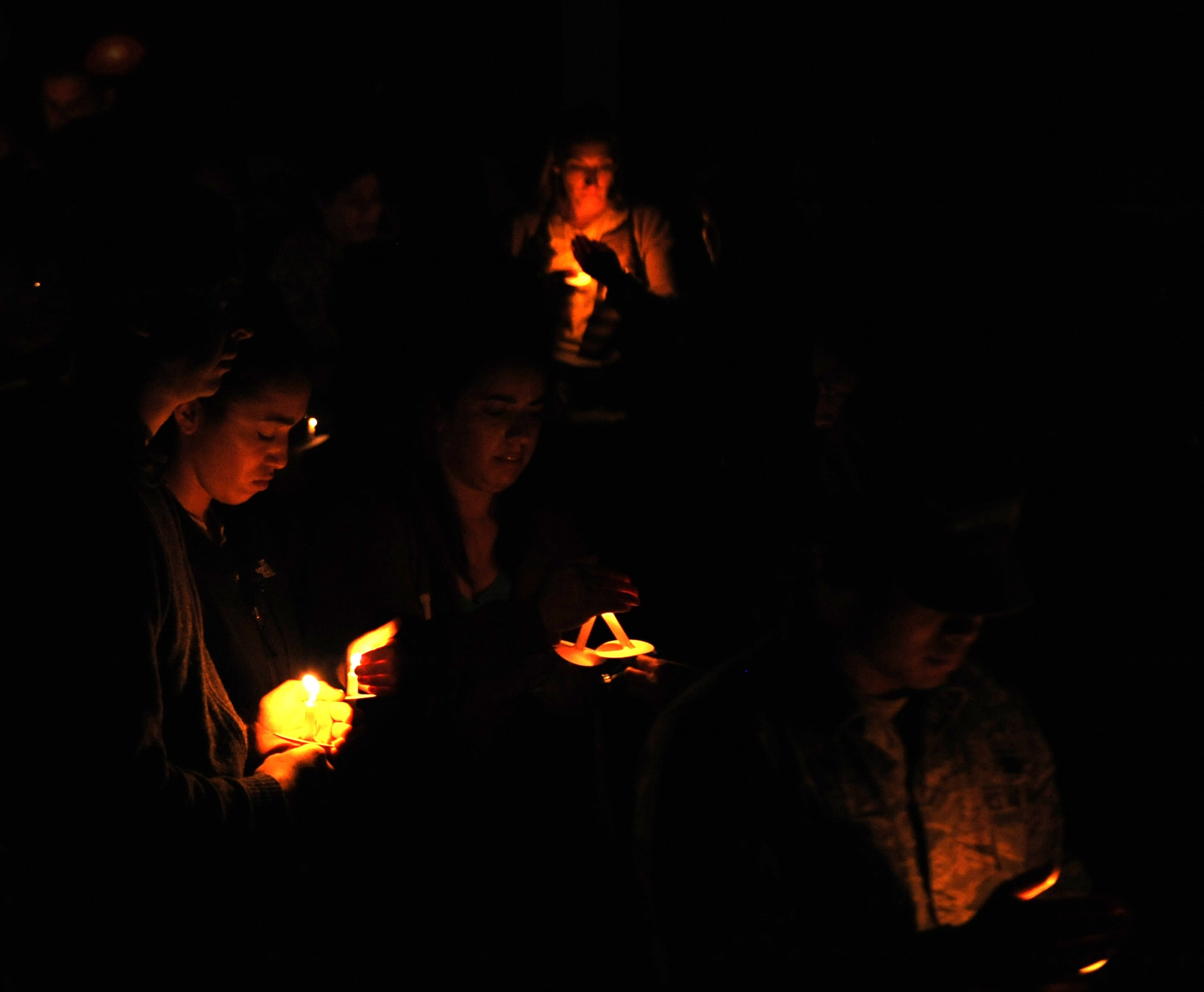 Volunteers and participants light candles in the Chapel 2 courtyard at a Sexual Assaul Prevention and Response's "Take Back the Night" event on Kadena Air Base, Japan, April 4, 2014. Kadena's SAPR team has been hosting events for Sexual Assault Awareness Month to raise hope and, at this event, remember those affected by sexual assault. (U.S. Air Force photo by Airman 1st Class Zackary A. Henry)