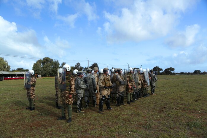 An international shield formation of Moroccan riot-control soldiers and U.S. Marine, Air Force and Army military police officers during Exercise African Lion 14, Tifnit, Morocco. Military police officers from the U.S. Marines, Army and Air Force, along with Royal Moroccan soldiers specializing in riot-control, found common ground as enforcers of the law during African Lion 14, an annually-scheduled, multilateral training engagement that is hosted by the Kingdom of Morocco. One of the largest of its kind on the continent, the engagement shows the commitment of the participating nations to military friendships, strategic partnerships and regional and global security.