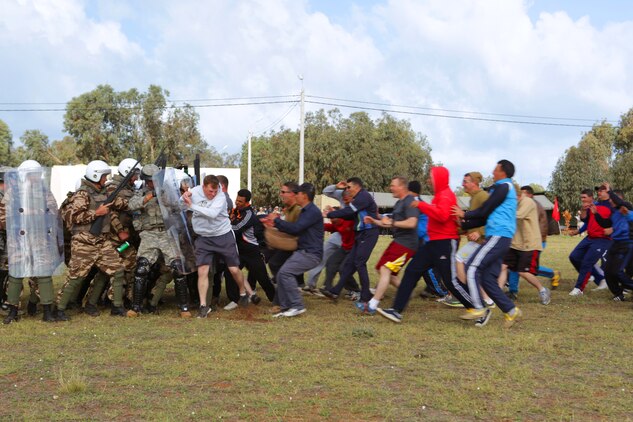 A demonstration by Royal Moroccan Armed Forces riot-control soldiers and their U.S. counterparts from the Marines, Army and Air Force demonstrate an escalation-of-force scenario during the Multinational Observer Program for African Lion 14. The U.S. Marine Corps Forces Europe and Africa-led engagement is one of the biggest of its kind on the continent and, during African Lion 14, hosted a multilateral event that included military observers from Mauritania, Egypt, Tunisia, Turkey, Great Britain, Belgium, the Netherlands, Portugal, Germany, Spain, Senegal, Poland, Turkey, Italy, and France.