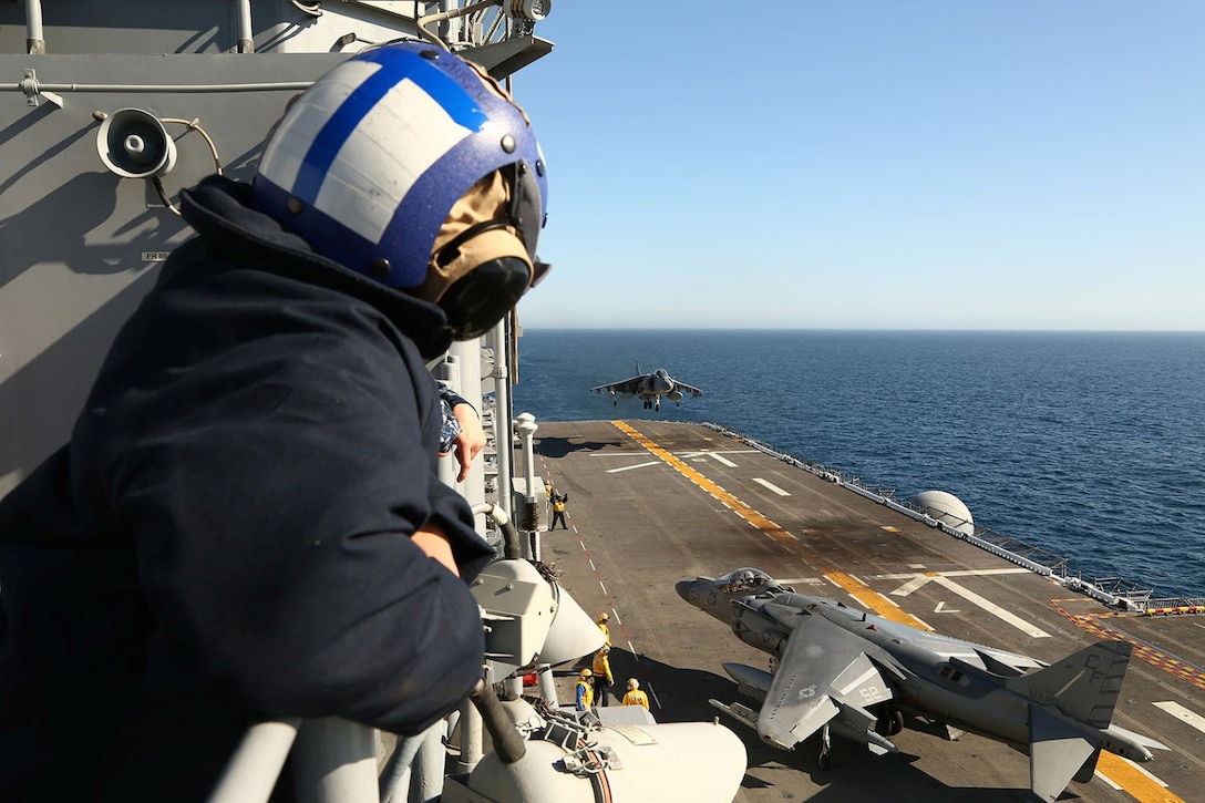 Sailors aboard the USS Makin Island watch as AV-8B Harriers with Marine Medium Tiltrotor Squadron 163 (Reinforced), 11th Marine Expeditionary Unit, land on the flight deck during Amphibious Squadron Marine Expeditionary Unit Integration Training (PMINT) off the coast of San Diego, Calif., April 7, 2014.  PMINT is a two-week predeployment training event focused on the combined capabilities of the MEU and Amphibious Ready Group (ARG), conducting amphibious operations, crisis response and limited contingency operations.  (U.S. Marine Corps photo by Lance Cpl. Laura Y Raga/Released)