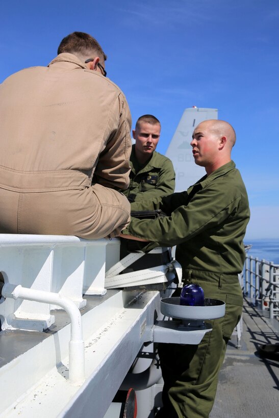 Marines with the 11th Marine Expeditionary Unit prepare the flight deck of the USS Makin Island for daytime flight operations during Amphibious Squadron Marine Expeditionary Unit Integration Training (PMINT) off the coast of San Diego, Calif. April 8. PMINT is the first at-sea event in the 11th MEU’s predeployment training program where the unit will conduct live training operations alongside the Makin Island Amphibious Ready Group.