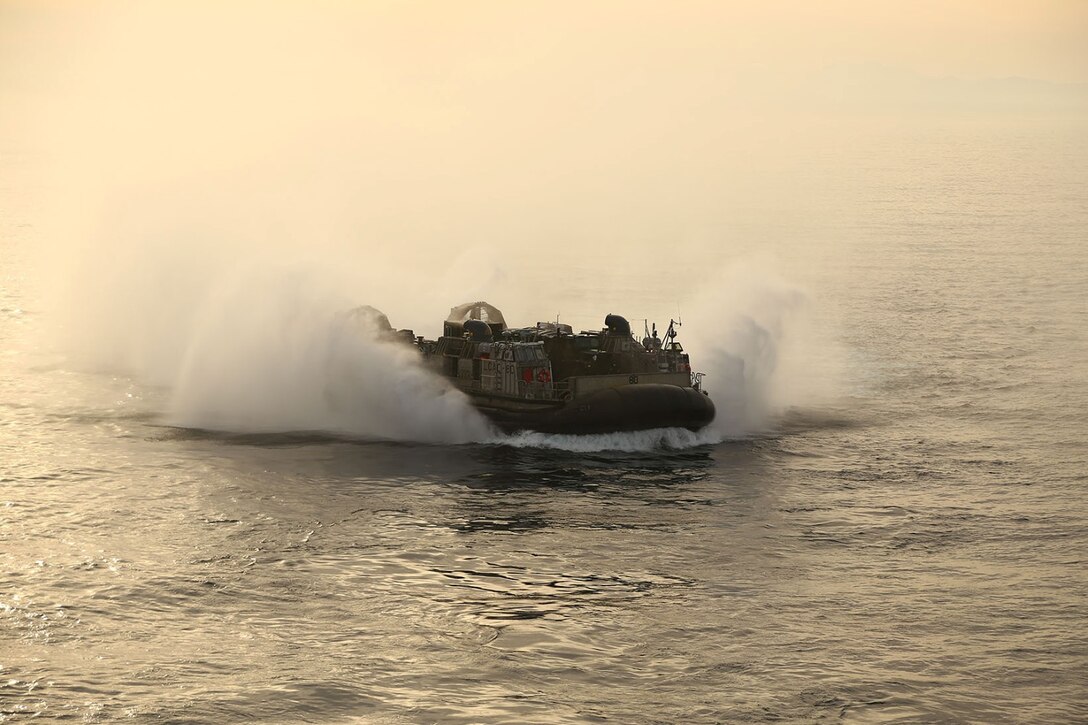 A landing craft air cushion (LCAC) maneuvers toward the USS Makin Island during Amphibious Squadron Marine Expeditionary Unit Integration Training (PMINT) off the coast of San Diego, Calif., April 9, 2014.  PMINT is a two-week predeployment training event focused on the combined capabilities of the MEU and Amphibious Ready Group (ARG), conducting amphibious operations, crisis response and limited contingency operations.  (U.S. Marine Corps photo by Lance Cpl. Laura Y. Raga/Released)