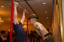 Staff Sgt. Robert M. Surozenski, a Drill Instructor from Marine Corps Recruit Depot San Diego, motivates a poolee during a partial Initial Strength Test at Recruiting Station Milwaukee’s Family Nights pool function, Apr. 5.  Family Nights give poolees their first glimpse into Marine Corps recruit training and allow family members to voice any questions or concerns they may have about recruit training.