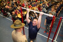 Morgan Daly, a poolee from Recruiting Substation Green Bay, performs pull-ups during a partial Initial Strength Test at RSS Green Bay’s Family Night pool function, Apr. 3.  Family Nights give poolees their first glimpse into Marine Corps recruit training and allow family members to voice any questions or concerns they may have about recruit training.