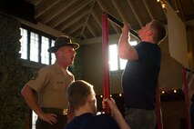 Staff Sgt. Nicholas A. Carrel, a Drill Instructor from Marine Corps Recruit Depot San Diego, motivates a poolee during a partial Initial Strength Test at Recruiting Substation Wausau’s Family Nights pool function, Apr. 1.  Family Nights give poolees their first glimpse into Marine Corps recruit training and allow family members to voice any questions or concerns they may have about recruit training.