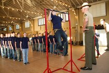 Poolees from Recruiting Substation Wausau perform pull-ups during a partial Initial Strength Test at RSS Wausau’s Family Night pool function, Apr. 1.  Family Nights give poolees their first glimpse into Marine Corps recruit training and allow family members to voice any questions or concerns they may have about recruit training.