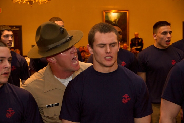 Sgt. Christapher M. Bess, a Drill Instructor from Marine Corps Recruit Depot San Diego, motivates a poolee during Recruiting Station Milwaukee’s Family Nights pool function, Apr. 5.  Family Nights give poolees their first glimpse into Marine Corps recruit training and allow family members to voice any questions or concerns they may have about recruit training.