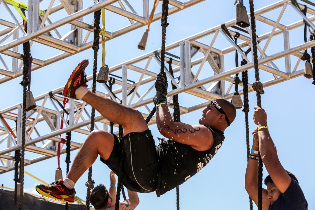Christopher Llanes, a Marine with 3rd Battalion, 5th Marine Regiment, makes it to the top of the rope obstacle during a Spartan Race event in Las Vegas, April 5, 2014. After reaching the top, Llanes rang the bell and yelled the names of three Marines who died in a car accident in February 2012.