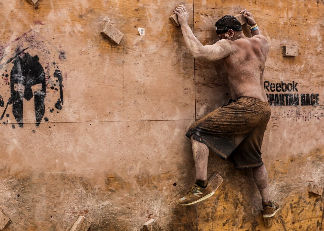 Jacob Martinez, a Marine with the 15th Marine Expeditionary Unit, makes his way across an obstacle during a Spartan Race in Las Vegas, April 5, 2014. Seven Marines from the 15th MEU, and other units aboard Camp Pendleton, ran the race in memory of three Marines who died in a car accident in February 2012. (U.S. Marine Corps photo by Cpl. Emmanuel Ramos/Released) 