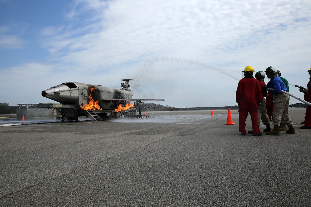 Marines with Marine Attack Squadron 542 fight an aircraft fire during training at Marine Corps Air Station Cherry Point, N.C., April 3,2014. Marines with VMA-542 learned the basics of shipboard firefighting in preparation for an upcoming deployment with the 31st Marine Expeditionary Unit.