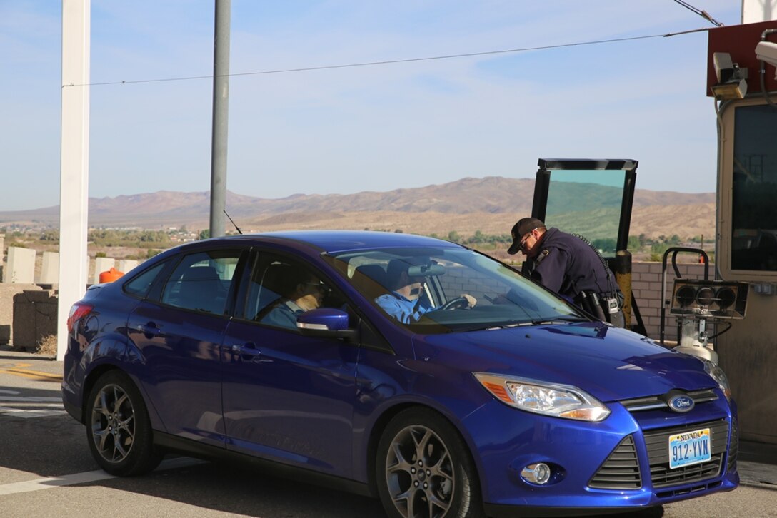 Corporal Lonnie Marney, police officer with the Marine Corps Police Department on Marine Corps Logistics Base Barstow, Calif., checks for proper registration, insurance and identification from a driver trying to access the installation, April 3.
