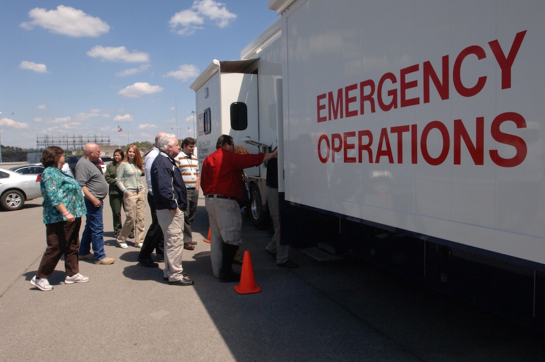 Representatives from local, state and federal agencies board a U.S. Army Corps of Engineers Emergency Command and Control Vehicle during a Silver Jackets meeting at Old Hickory Dam in Old Hickory, Tenn., April 9, 2014. The group learned about the capabilities of the Army's command and control asset.