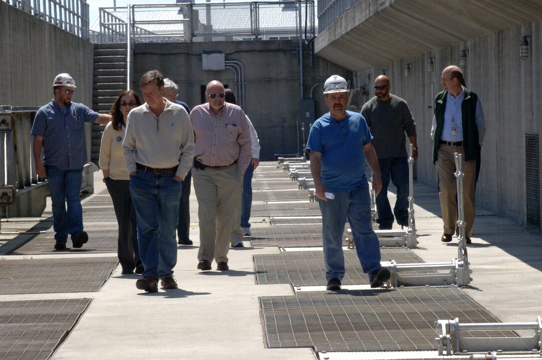 Dirk Cundiff (Left) and Chris Sherek (Third from right) lead a U.S. Army Corps of Engineers Nashville District tour of the Old Hickory Hydropower plant for local, state and federal participants of a Silver Jackets meeting at Old Hickory Dam in Old Hickory, Tenn., April 9, 2014. The hydropower plant is located on the Hendersonville, Tenn., side of the Cumberland River. Silver Jackets is a program that promotes cohesive solutions and synchronizes plans and programs between local, state and federal agencies.