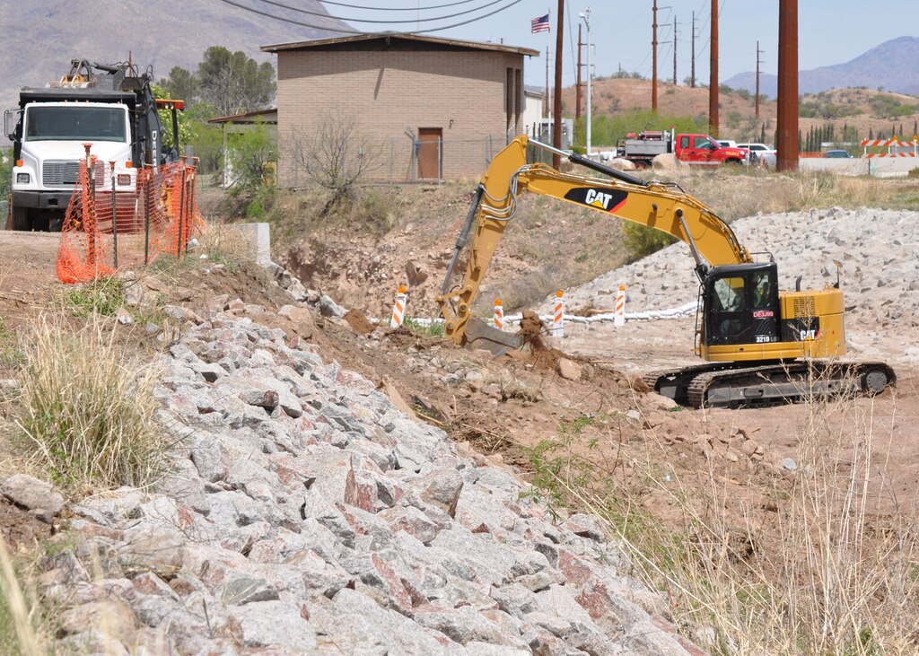 Workers with West Point Contractors, Inc., the U.S. Army Corps of Engineer Los Angeles District’s contractor, clear rocks and vegetation Apr. 9 as they prepare to construct a bridge across the Chula Vista Wash in Nogales, Ariz. The $4M project will consist of constructing a two-span, I-girder concrete bridge, install associated road base and approach slabs, and placing grouted riprap both upstream and downstream of the project in the channel.