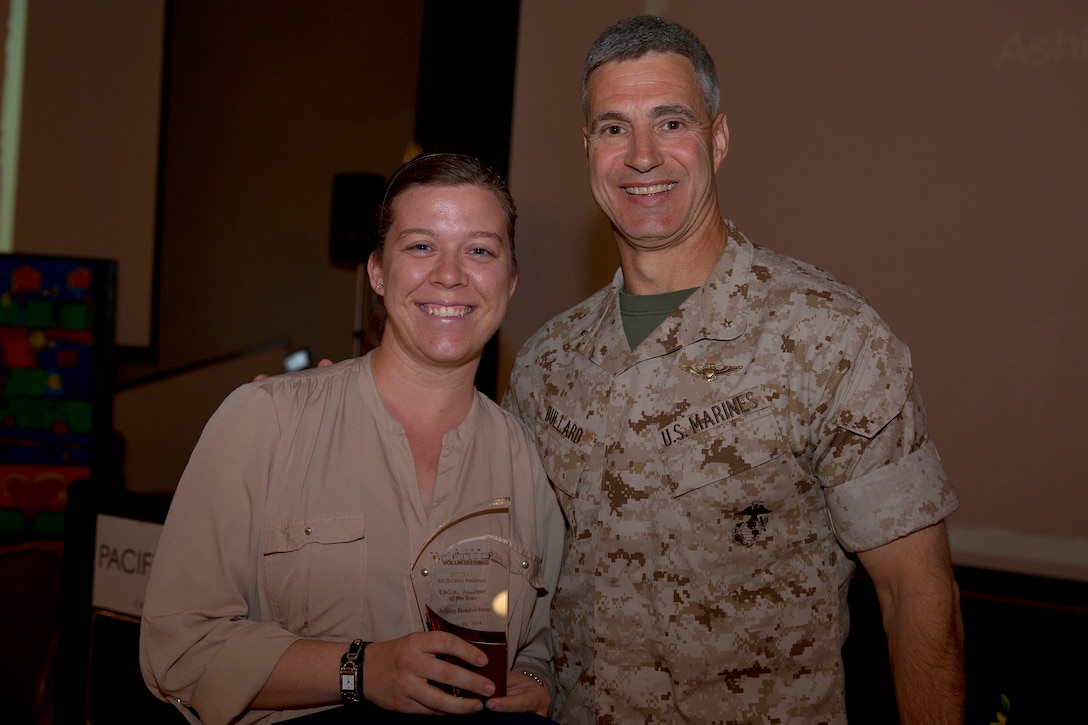 Ashley Hendricks, recipient of the Civilian Volunteer of the Year award, poses with Brig. Gen. John W. Bullard, commanding general of Marine Corps Installations-West, during the 2014 Volunteer Recognition Ceremony at the Pacific Views Event Center April 10. More than 6,000 military and civilian volunteers from several units on Camp Pendleton accumulated a total of 110,461 hours of volunteer service in 2013. 