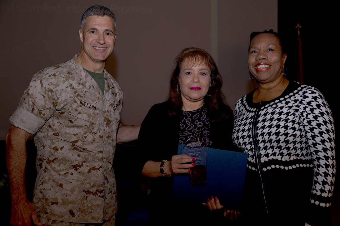 Representatives for Words of Comfort, Hope and Promise, the team awarded with the Team Volunteer of the Year award, pose with Brig. Gen. John W. Bullard, commanding general of Marine Corps Installations-West, during the 2014 Volunteer Recognition Ceremony at the Pacific Views Event Center April 10. More than 6,000 military and civilian volunteers from several units on Camp Pendleton accumulated a total of 110,461 hours of volunteer service in 2013. 