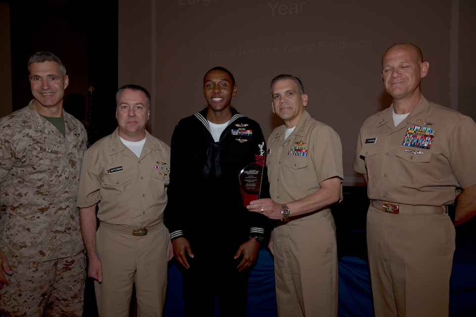 Representatives for Naval Hospital Camp Pendleton, the unit awarded with Large Unit Volunteer of the Year award, pose with Brig. Gen. John W. Bullard, commanding general of Marine Corps Installations-West, during the 2014 Volunteer Recognition Ceremony at the Pacific Views Event Center April 10. More than 6,000 military and civilian volunteers from several units on Camp Pendleton accumulated a total of 110,461 hours of volunteer service in 2013.  