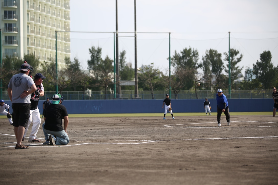 Community and U.S. service members play softball April 5 after the third annual Ginowan Tropical Beach Cleanup in Ginowan City, Okinawa. Ginowan City residents and Marines worked together to clean Tropical Beach, and participated in a friendly softball game and barbecue afterwards. The Marines are with Marine Aviation Logistics Squadron 36, Marine Aircraft Group 36, 1st Marine Aircraft Wing, III Marine Expeditionary Force. 