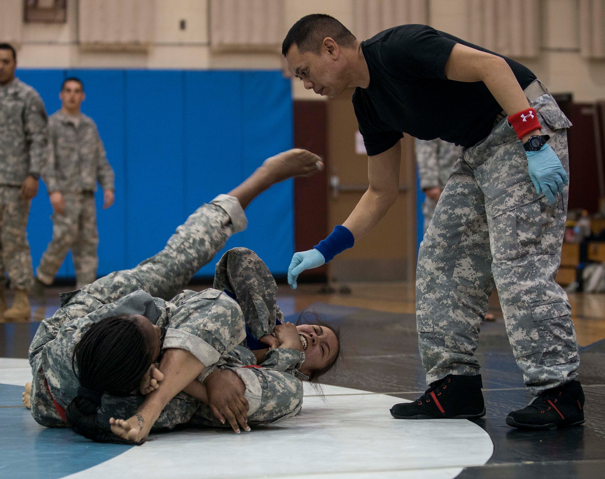 Two soldiers grapple during an Army combatatives tournament March 19, 2014, at Osan Air Base, Republic of Korea. The competition involves competitors facing off against each other, in an effort to make the other submit. (U.S. Air Force photo by Staff Sgt. Jake Barreiro)